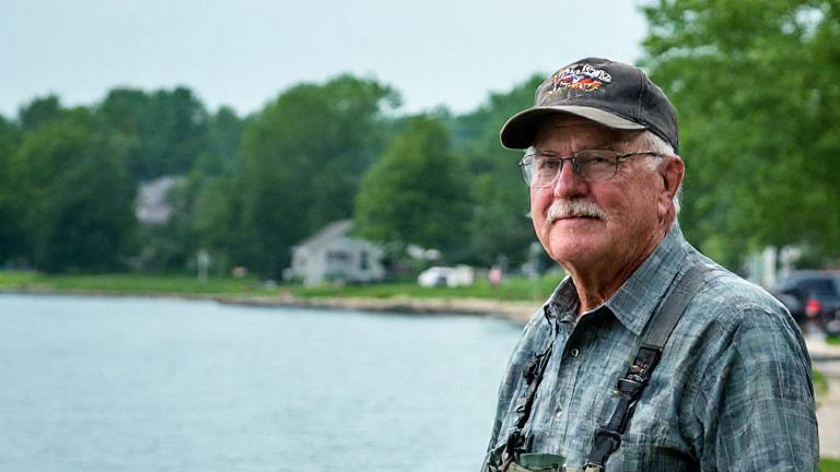 nurse in scrubs walking through Vermilion city park with American flag pin
