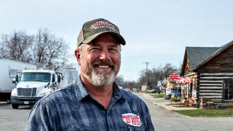 truck driver with "Vermilion Pride" sticker on cab, laughing at a spill on his shirt